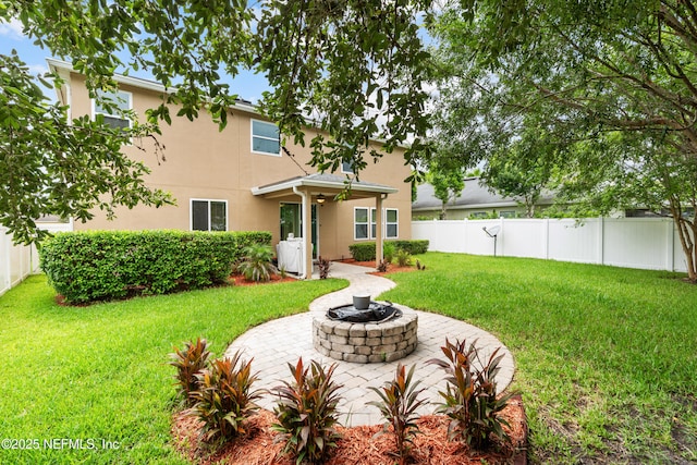 4749 Creek Bluff Ln, Middleburg, FL 32068 - back of house with stucco siding, a fenced backyard, a fire pit, and a patio