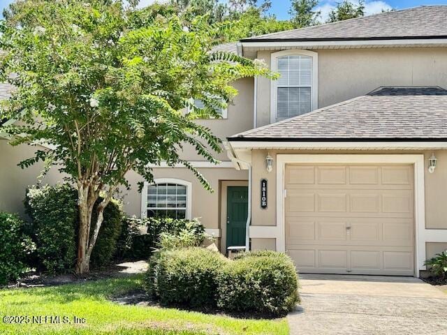 1810 Green Springs Cir Unit B, Fleming Island, FL 32003 - view of front of house featuring stucco siding, driveway, and roof with shingles