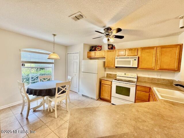 1810 Green Springs Cir Unit B, Fleming Island, FL 32003 - kitchen featuring white appliances, a ceiling fan, light tile patterned floors, decorative light fixtures, and a textured ceiling