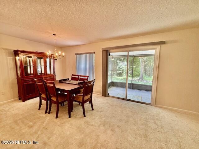 1810 Green Springs Cir Unit B, Fleming Island, FL 32003 - dining room with a chandelier, a textured ceiling, and light colored carpet