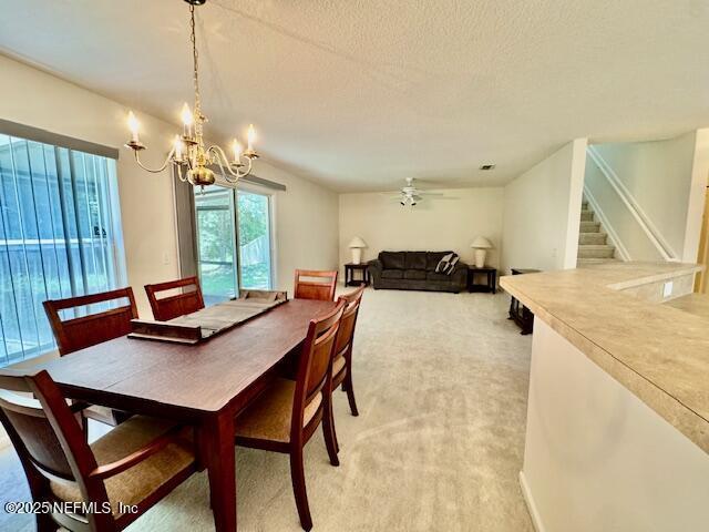 1810 Green Springs Cir Unit B, Fleming Island, FL 32003 - dining room featuring light carpet, a chandelier, stairway, ceiling fan, and a textured ceiling