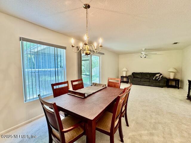 1810 Green Springs Cir Unit B, Fleming Island, FL 32003 - dining space featuring light colored carpet, a chandelier, a textured ceiling, and ceiling fan