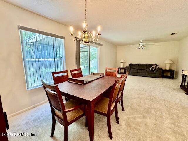 1810 Green Springs Cir Unit B, Fleming Island, FL 32003 - dining area featuring healthy amount of natural light, light carpet, a chandelier, and ceiling fan