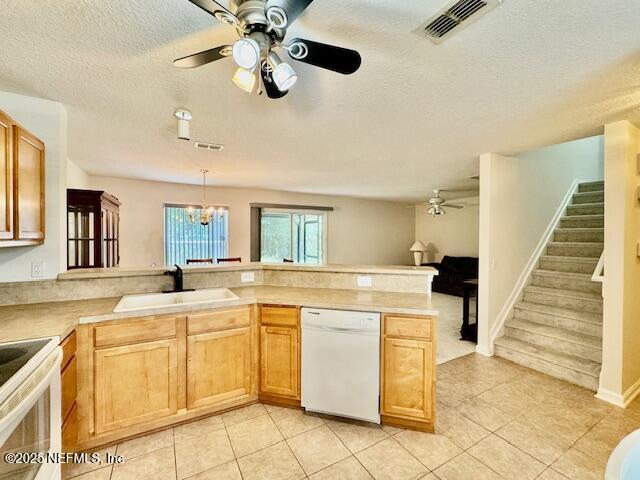 1810 Green Springs Cir Unit B, Fleming Island, FL 32003 - kitchen with dishwasher, a ceiling fan, light tile patterned floors, a peninsula, and a textured ceiling