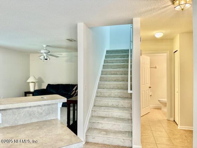 1810 Green Springs Cir Unit B, Fleming Island, FL 32003 - staircase featuring a textured ceiling, tile patterned floors, and a ceiling fan
