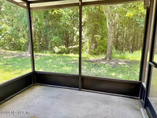 1810 Green Springs Cir Unit B, Fleming Island, FL 32003 - unfurnished sunroom featuring a view of trees