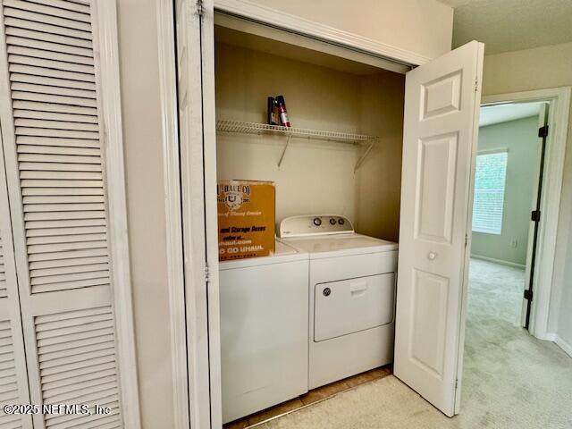 1810 Green Springs Cir Unit B, Fleming Island, FL 32003 - washroom with washing machine and clothes dryer and light colored carpet
