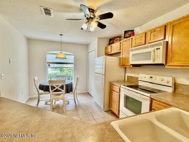 1810 Green Springs Cir Unit B, Fleming Island, FL 32003 - kitchen featuring white appliances, light tile patterned floors, a textured ceiling, hanging light fixtures, and ceiling fan