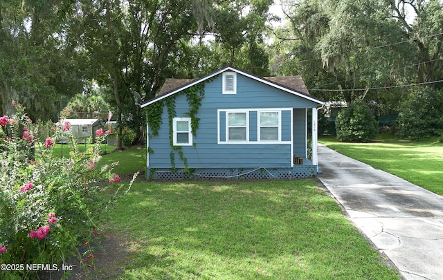 1213 Idlewild Ave, Green Cove Springs, FL 32043 - view of property exterior featuring concrete driveway, a yard, and roof with shingles