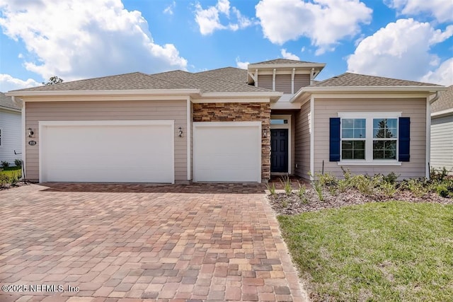 85328 Stonehurst Pkwy, Fernandina Beach, FL 32034 - prairie-style home with decorative driveway, a garage, and a front yard