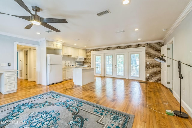 10268 Lake View Rd W, Jacksonville, FL 32225 - unfurnished living room with ornamental molding, ceiling fan, light wood-type flooring, brick wall, and recessed lighting