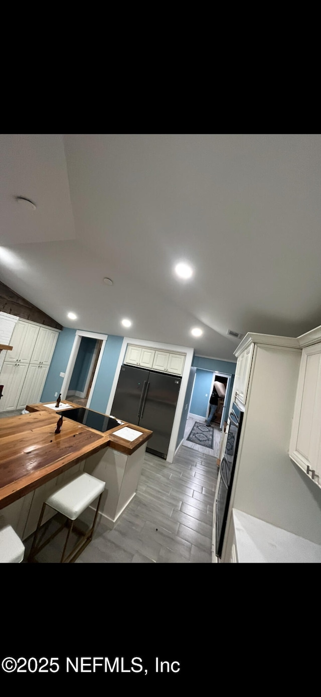10268 Lake View Rd W, Jacksonville, FL 32225 - kitchen with white cabinetry, wood counters, and recessed lighting