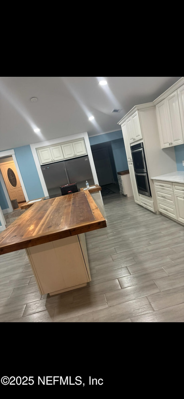 10268 Lake View Rd W, Jacksonville, FL 32225 - kitchen featuring wooden counters, light wood-type flooring, and white cabinetry