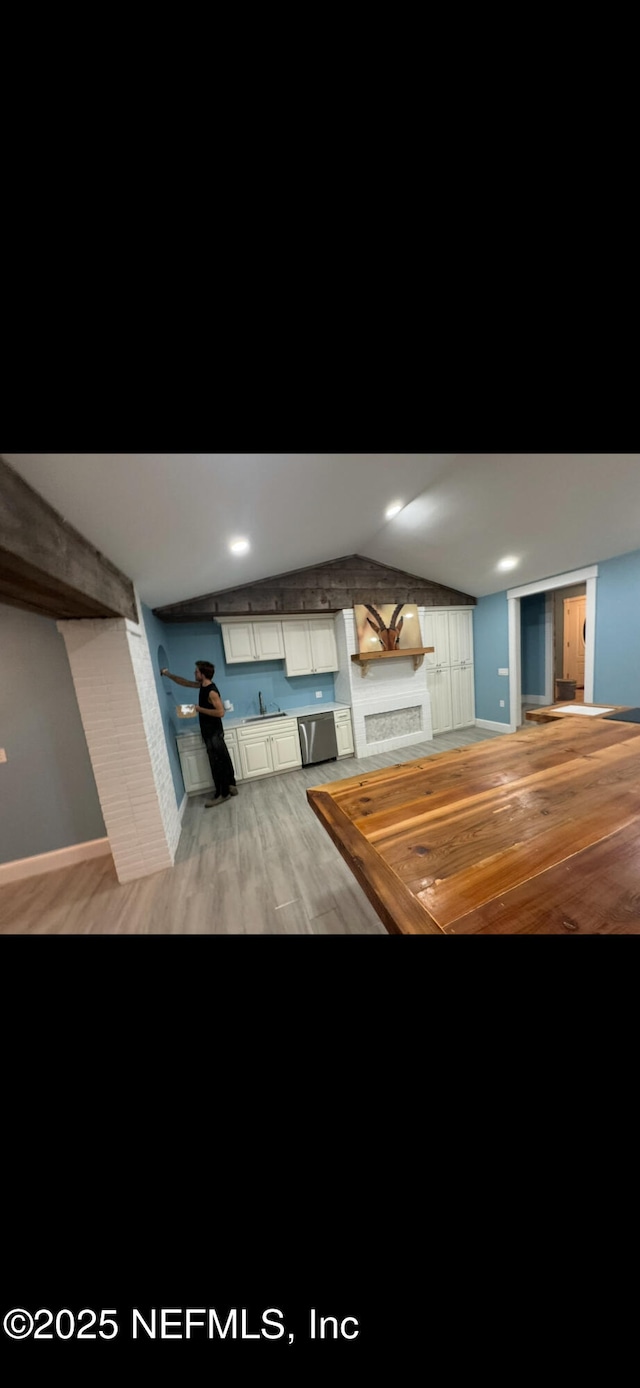 10268 Lake View Rd W, Jacksonville, FL 32225 - kitchen featuring butcher block counters, light wood-type flooring, dishwasher, vaulted ceiling, and open shelves