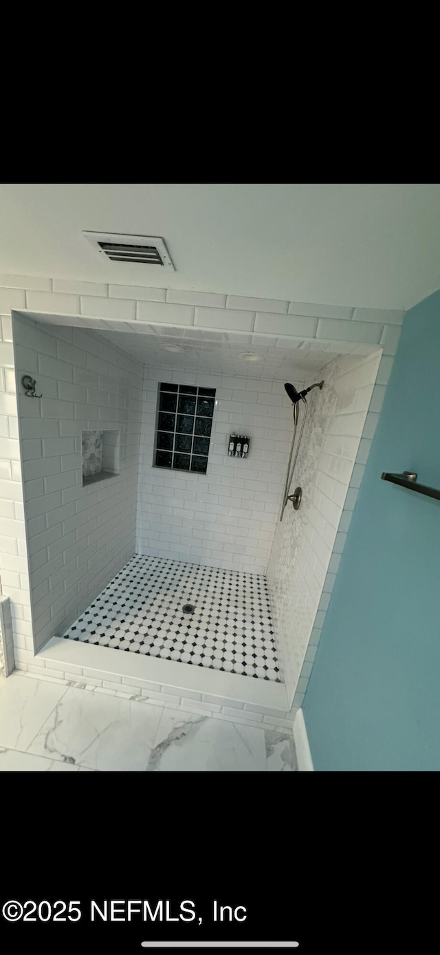 10268 Lake View Rd W, Jacksonville, FL 32225 - bathroom with a tile shower and marble finish floors