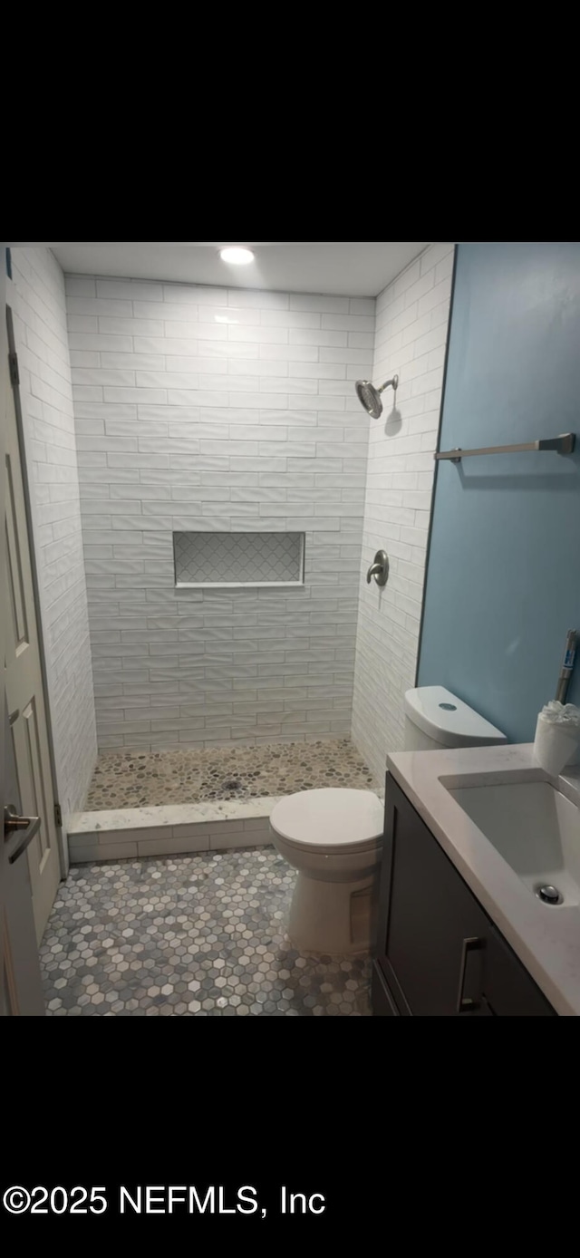 10268 Lake View Rd W, Jacksonville, FL 32225 - bathroom with vanity, tiled shower, and tile patterned flooring