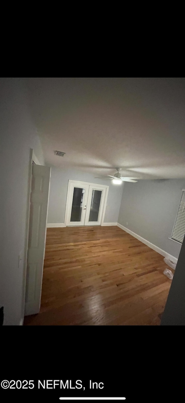 10268 Lake View Rd W, Jacksonville, FL 32225 - unfurnished room featuring wood finished floors, a ceiling fan, and french doors