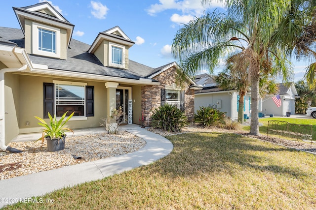 321 Palazzo Cir, Saint Augustine, FL 32092 - view of front of property with a front yard, stucco siding, stone siding, and roof with shingles