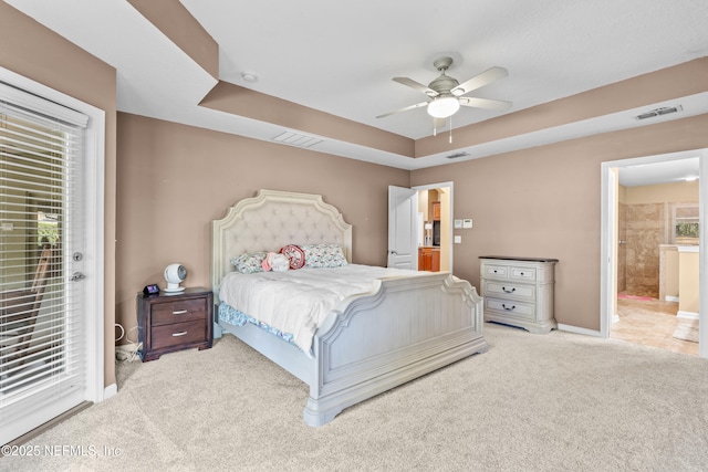321 Palazzo Cir, Saint Augustine, FL 32092 - carpeted bedroom with access to exterior, a tray ceiling, ensuite bathroom, ceiling fan, and multiple windows
