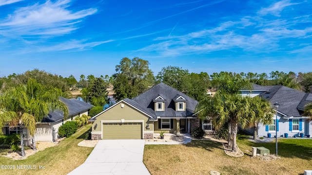 321 Palazzo Cir, Saint Augustine, FL 32092 - view of front facade with an attached garage, concrete driveway, a front yard, and stucco siding