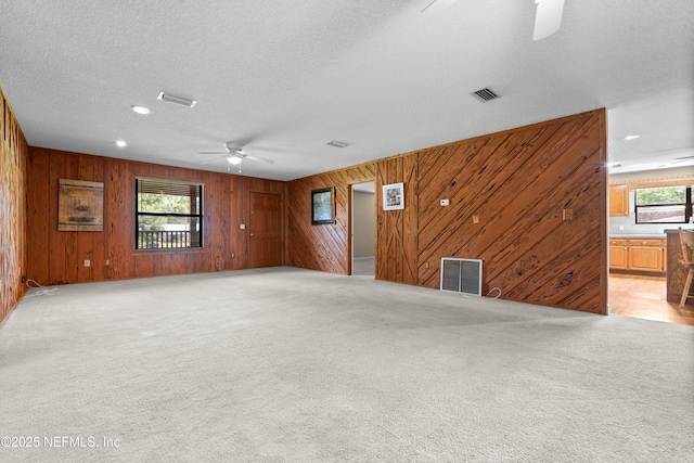 6032 Bob Kirkland Rd, Macclenny, FL 32063 - empty room with ceiling fan, wooden walls, light carpet, a textured ceiling, and recessed lighting