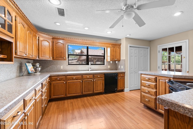 6032 Bob Kirkland Rd, Macclenny, FL 32063 - kitchen with dishwasher, brown cabinets, light wood finished floors, backsplash, and a textured ceiling