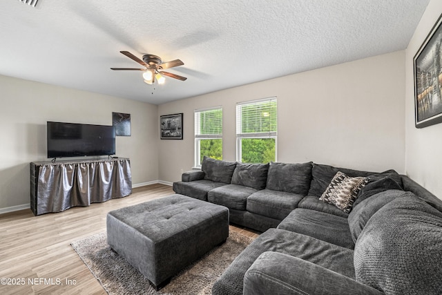 3299 Hidden Meadows Ct, Green Cove Springs, FL 32043 - living room featuring light wood finished floors, a ceiling fan, and a textured ceiling