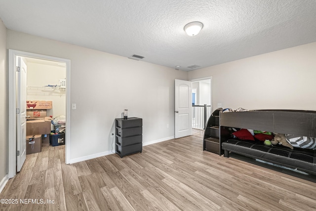 3299 Hidden Meadows Ct, Green Cove Springs, FL 32043 - bedroom featuring light wood-type flooring and a textured ceiling