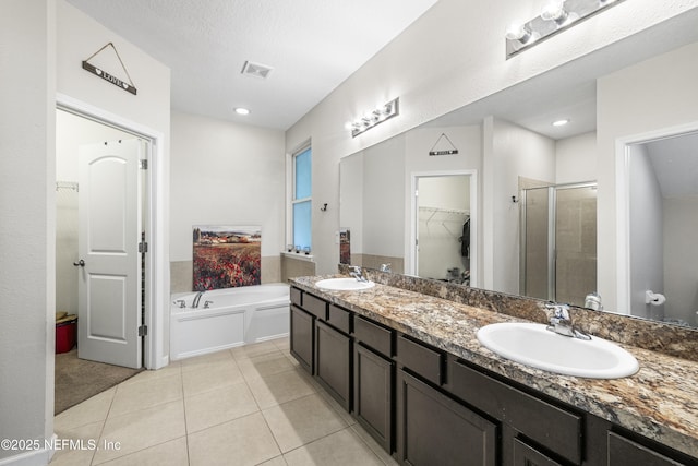 3299 Hidden Meadows Ct, Green Cove Springs, FL 32043 - full bath with a walk in closet, a shower stall, a bath, double vanity, and tile patterned flooring