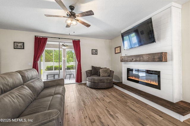 3299 Hidden Meadows Ct, Green Cove Springs, FL 32043 - living room featuring ceiling fan, a large fireplace, and wood finished floors