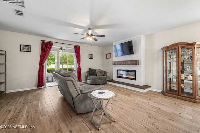 3299 Hidden Meadows Ct, Green Cove Springs, FL 32043 - living room featuring a ceiling fan, wood finished floors, and a fireplace