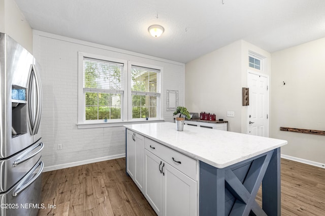 3299 Hidden Meadows Ct, Green Cove Springs, FL 32043 - kitchen with stainless steel fridge with ice dispenser, dark wood-style floors, white cabinetry, and light stone counters