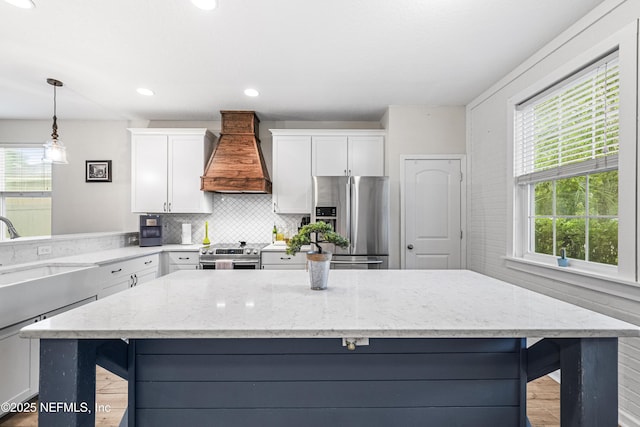 3299 Hidden Meadows Ct, Green Cove Springs, FL 32043 - kitchen with appliances with stainless steel finishes, custom exhaust hood, white cabinets, light stone countertops, and recessed lighting