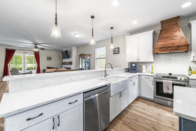 3299 Hidden Meadows Ct, Green Cove Springs, FL 32043 - kitchen featuring appliances with stainless steel finishes, custom range hood, a peninsula, tasteful backsplash, and ceiling fan