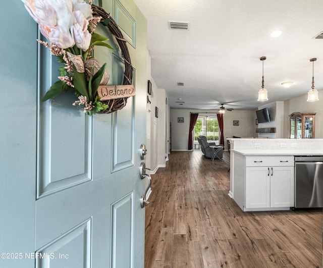 3299 Hidden Meadows Ct, Green Cove Springs, FL 32043 - kitchen featuring dishwasher, white cabinetry, open floor plan, wood finished floors, and hanging light fixtures