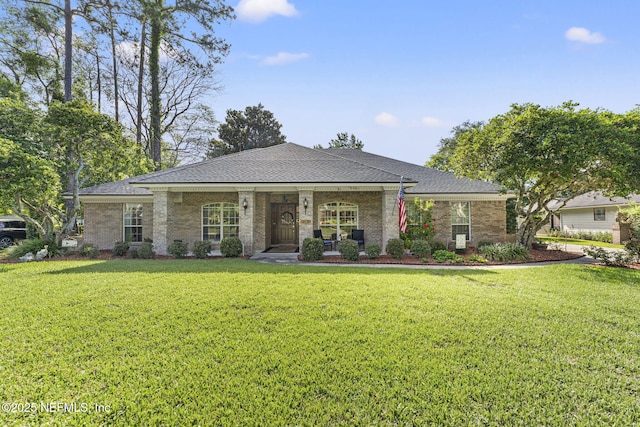1565 Royal Fern Ln, Fleming Island, FL 32003 - view of front of property featuring a front lawn, brick siding, a shingled roof, and a porch