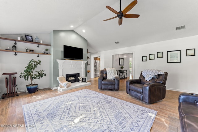1565 Royal Fern Ln, Fleming Island, FL 32003 - living room featuring ceiling fan, a fireplace with raised hearth, high vaulted ceiling, wood finished floors, and recessed lighting