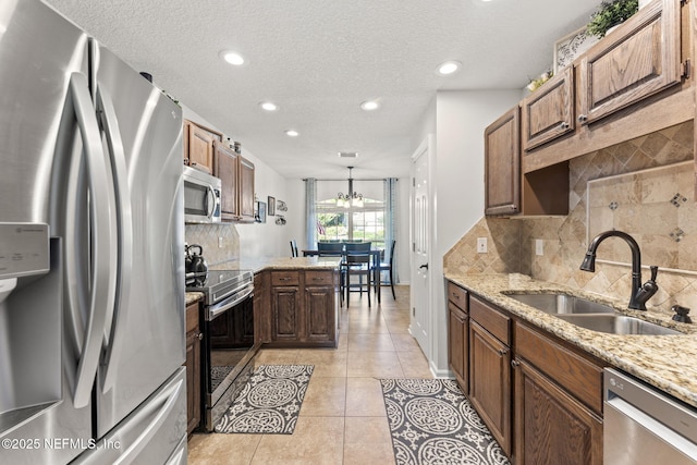 1565 Royal Fern Ln, Fleming Island, FL 32003 - kitchen with appliances with stainless steel finishes, tasteful backsplash, light stone counters, light tile patterned flooring, and recessed lighting