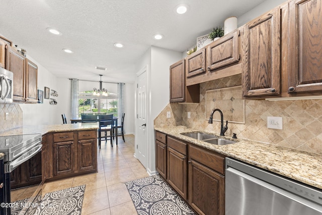 1565 Royal Fern Ln, Fleming Island, FL 32003 - kitchen with appliances with stainless steel finishes, light tile patterned floors, tasteful backsplash, recessed lighting, and light stone counters