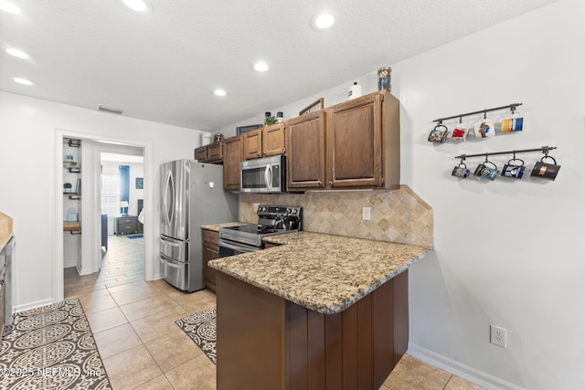 1565 Royal Fern Ln, Fleming Island, FL 32003 - kitchen featuring stainless steel appliances, backsplash, light stone counters, recessed lighting, and a peninsula