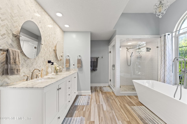 1565 Royal Fern Ln, Fleming Island, FL 32003 - bathroom featuring a shower stall, a freestanding tub, and double vanity