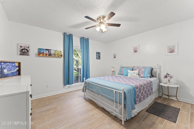 1565 Royal Fern Ln, Fleming Island, FL 32003 - bedroom with light wood-style flooring, a textured ceiling, and a ceiling fan