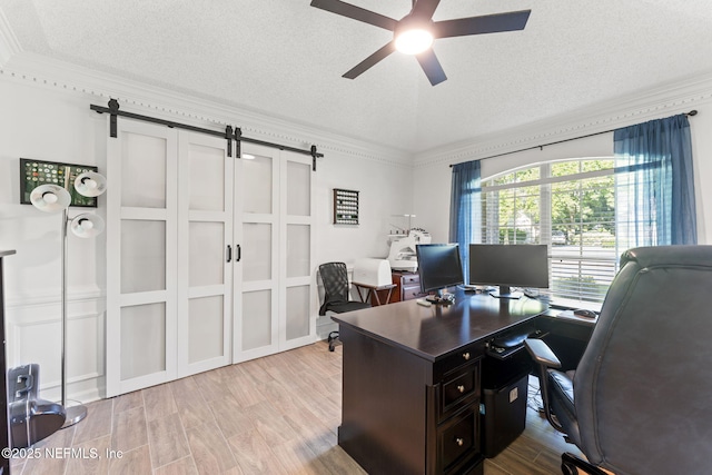 1565 Royal Fern Ln, Fleming Island, FL 32003 - office featuring a barn door, a textured ceiling, a ceiling fan, wood finished floors, and ornamental molding