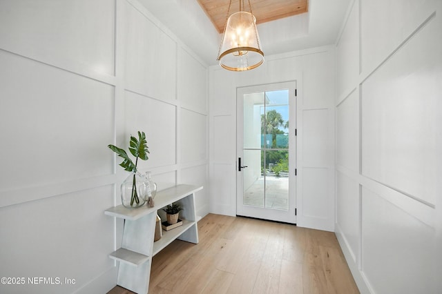 1509 Ocean Front, Neptune Beach, FL 32266 - doorway with a decorative wall, light wood-style flooring, and a chandelier