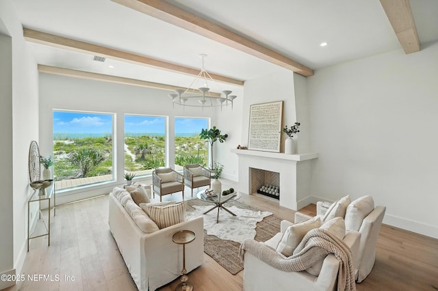1509 Ocean Front, Neptune Beach, FL 32266 - living area with beam ceiling, a chandelier, wood finished floors, recessed lighting, and a fireplace