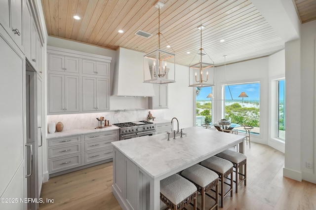 1509 Ocean Front, Neptune Beach, FL 32266 - kitchen featuring range with two ovens, wood ceiling, custom range hood, recessed lighting, and a chandelier
