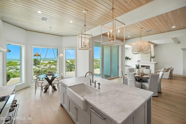 1509 Ocean Front, Neptune Beach, FL 32266 - kitchen with a chandelier, wooden ceiling, light wood-type flooring, light stone countertops, and pendant lighting