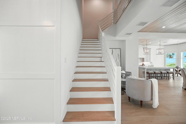 1509 Ocean Front, Neptune Beach, FL 32266 - staircase featuring wood finished floors, a chandelier, and recessed lighting