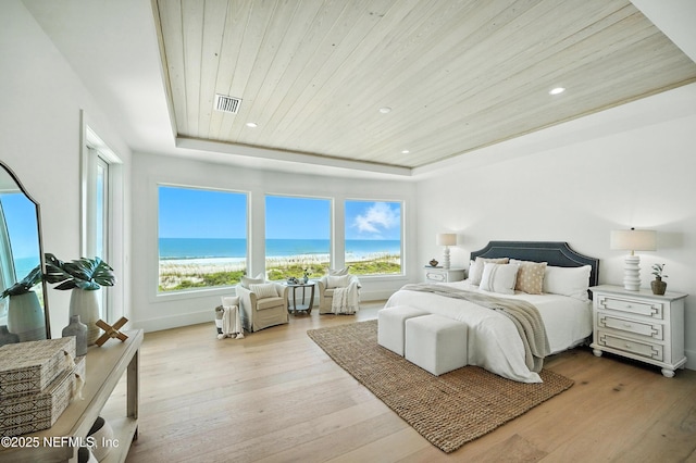 1509 Ocean Front, Neptune Beach, FL 32266 - bedroom with wooden ceiling, wood finished floors, a raised ceiling, a water view, and recessed lighting
