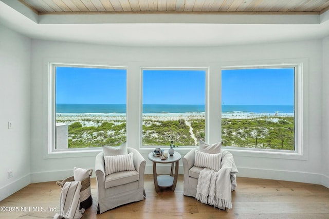 1509 Ocean Front, Neptune Beach, FL 32266 - sitting room featuring wooden ceiling, view of water and beach, and wood finished floors